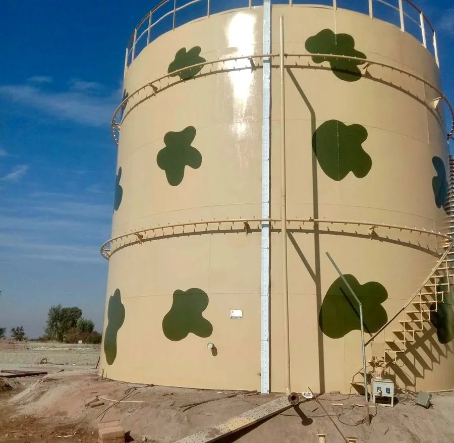 5,000 barrel crude oil storage tank at OGDCL Dhakni with distinctive camouflage paint scheme